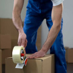R&B Removals packing a cardboard box